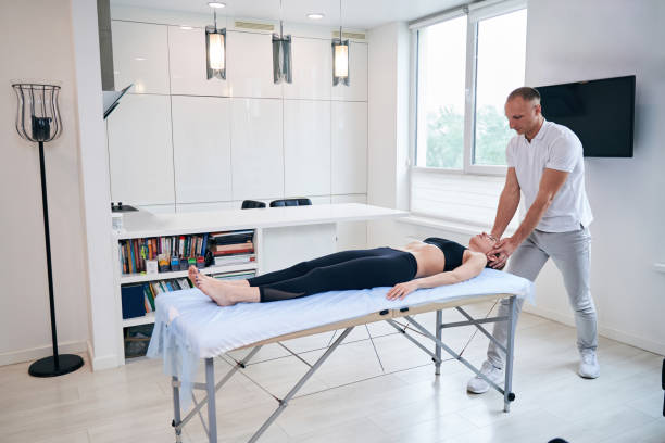 istock Young elegant lady in black sportswear lying on massage table 1337261723