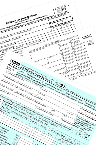 2021 IRS tax forms on a white desktop.