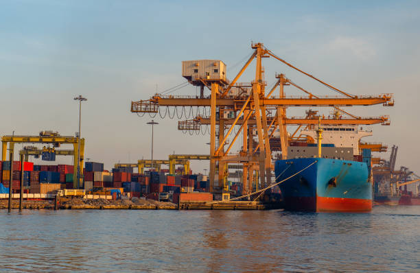 istock Container ship in export and import business and logistics. Shipping cargo to harbor by crane. Water transport International. Aerial view and top view. 1337263554