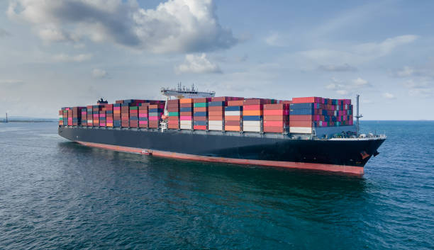 istock Container ship in export and import business and logistics. Shipping cargo to harbor by crane. Water transport International. Aerial view and top view. 1337263675