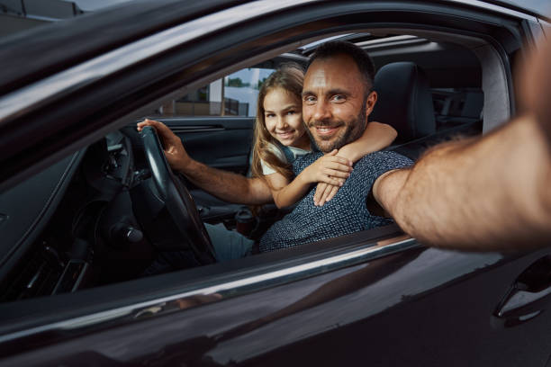 Caring father taking selfie with his child before the trip