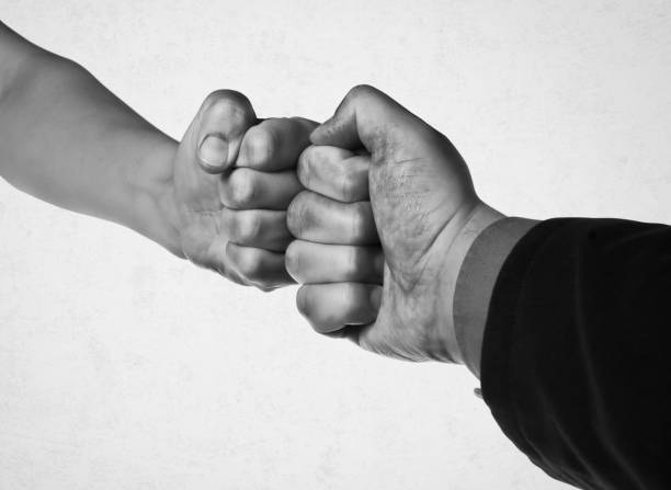 istock Clash of two fists. Black and white. 1337264724