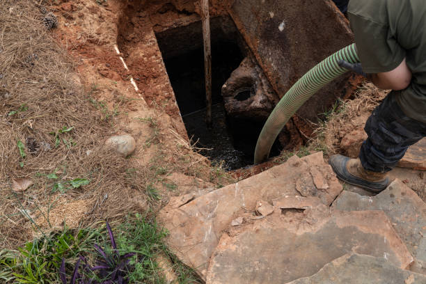 istock Man pumping sludge from a newly opened septic tank 1337266292