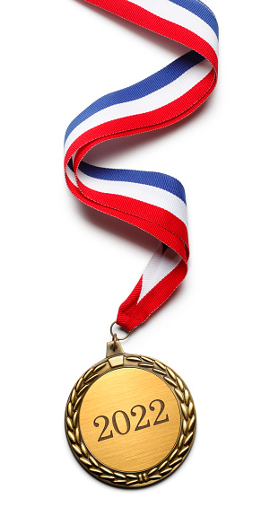 A gold medal inscribed with 2022 on a white background.  It is attached to a red, white, and blue ribbon. A clipping path is included.