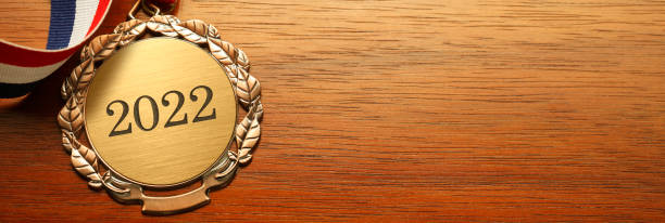 istock Gold Medal Engraved With  The Year 2022 On Wood Surface 1337266512
