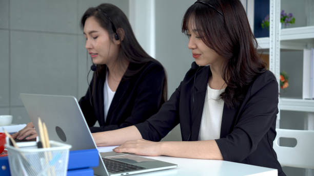 istock Call center or telemarketing taking notes and answering customer questions. 1337266716