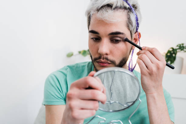 istock Drag queen applying make up indoors at home - Lgbt concept - Focus on eyes 1337270342
