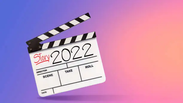 2022 story.Text title on film slate or movie clapboard for the filmmaker.storytelling concept on multicolor background
