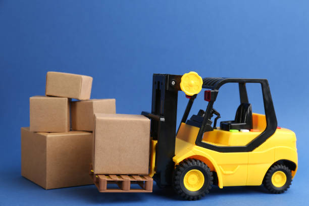 istock Forklift model and carton boxes on blue background. Courier service 1337272755