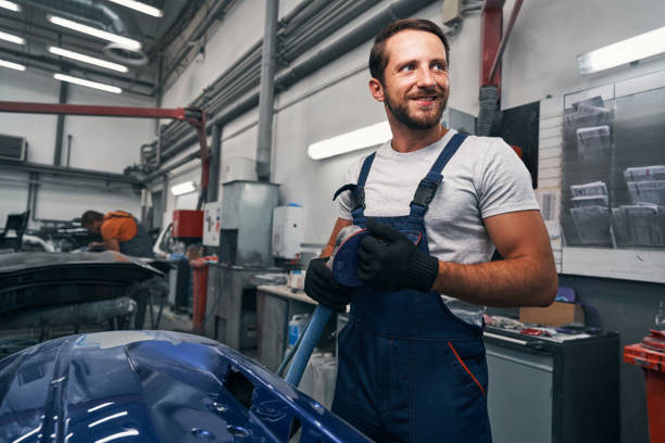 istock Male car workshop worker taking care of sander after work 1337273583
