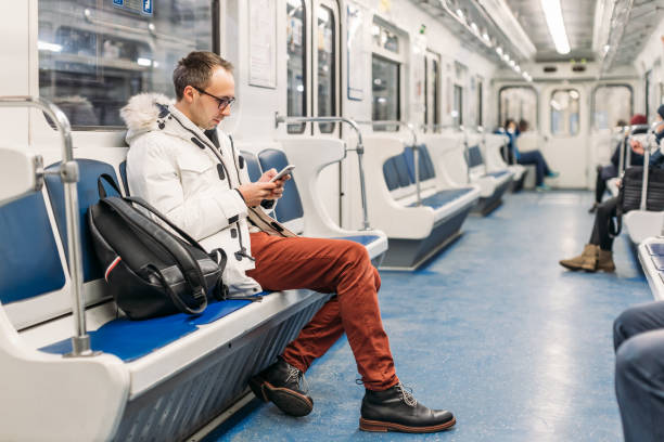 istock Handsome adult man in glasses with black backpack riding in subway train. 1337274665