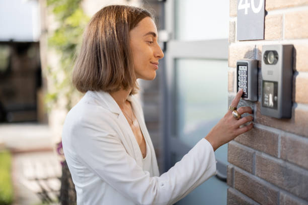 istock Woman entering code on a keyboard to access a door 1337276094