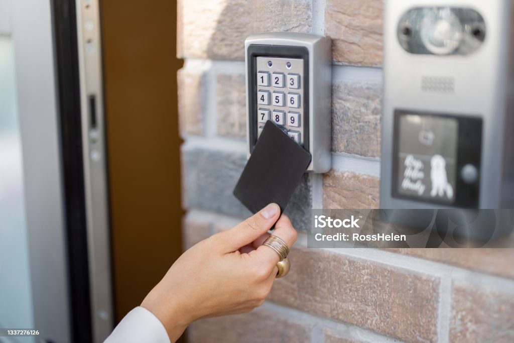 Attaching card to the electronic reader to access the office or apartment Attaching card to the electronic reader to access the office or apartment, close-up. Card entry, personal identification, keyless access, modern technologies concept Accessibility Stock Photo