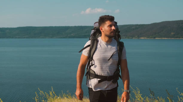 istock The traveler walking with backpack along the coast 1337278235