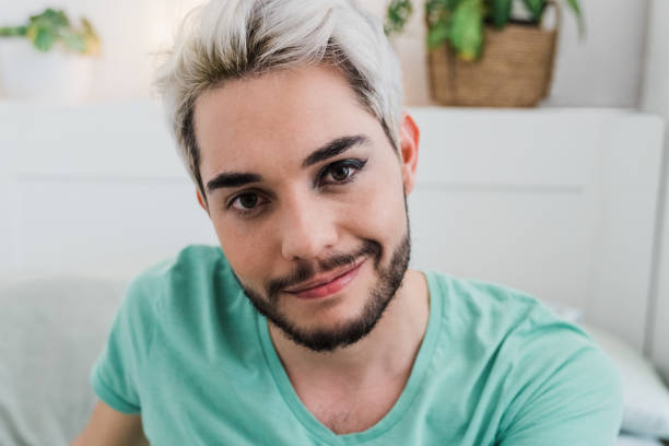 istock Drag queen looking at camera indoors at home - Focus on face 1337280284