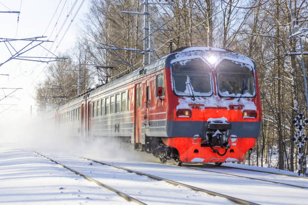 istock Electric suburban train drives passing by through a snowy park. 1337281676