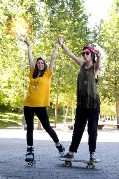 istock happy girls shaking hands and posing with roller skates 1337283405
