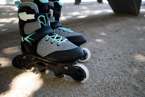 inline skates in the foreground resting on the ground