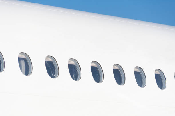 istock Windows on a white aircraft fuselage outdoor. 1337284930