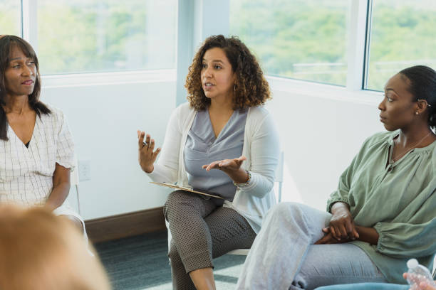 istock Employee engagement group leader gestures as members listen 1337285019