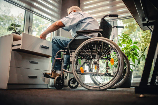 istock Disabled senior man in a wheelchair in a office 1337285151