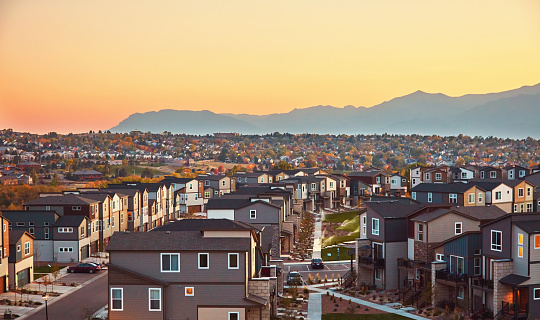 Residential Community in Western USA with Modern Homes at Sunrise and Mountains in Background