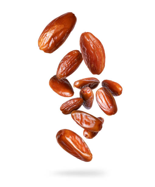 istock Delicious dried dates in the air isolated on white background 1337286578