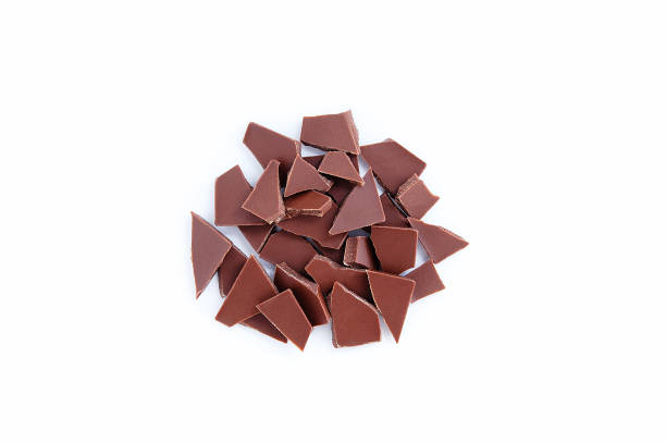 istock Broken pieces of milk chocolate in bunch on a white background. 1337288164