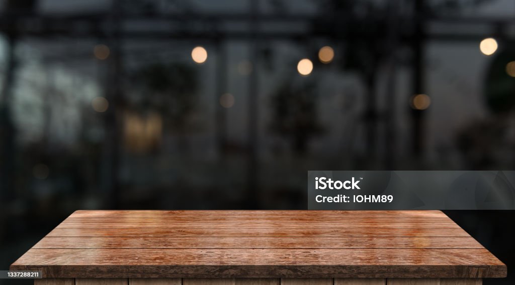 Empty wooden table top with lights bokeh on blur restaurant background Table Stock Photo