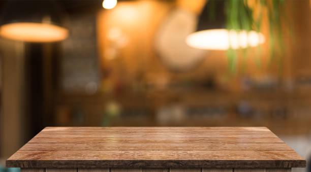 istock Empty wooden table top with lights bokeh on blur restaurant background 1337288212