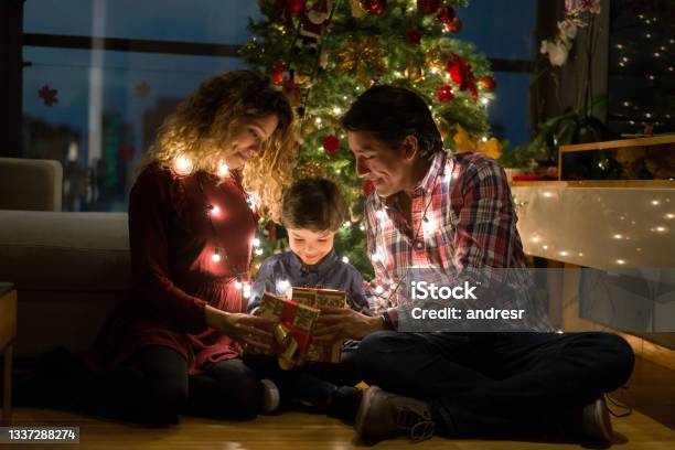 Happy Family Opening Christmas Presents Stock Photo - Download Image Now - Christmas, Family, Christmas Present