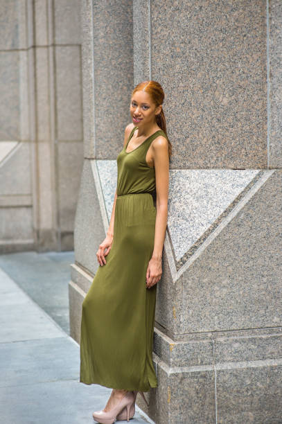 istock Young woman standing outdoors in New York City, looking forward 1337290406