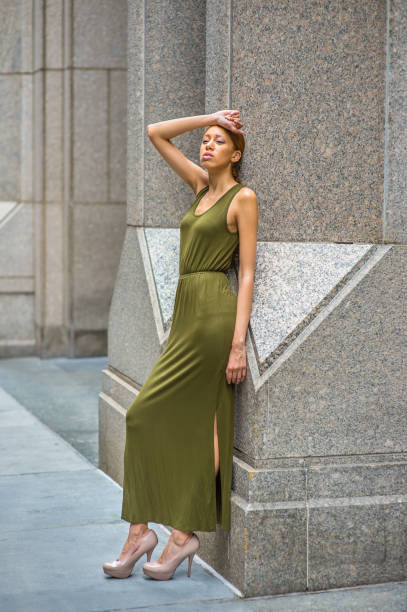 istock Young woman standing outdoors in New York City, looking forward 1337290426
