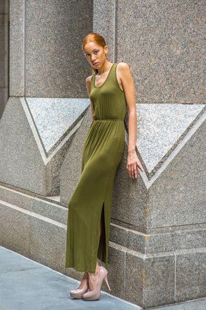 istock Young woman standing outdoors in New York City, looking forward 1337290431
