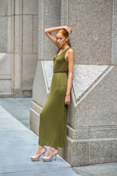 istock Young woman standing outdoors in New York City, looking forward 1337290437