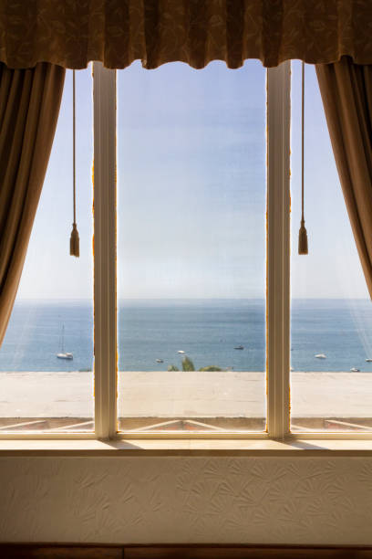 istock Windows with curtains, with a view to the sea 1337292122