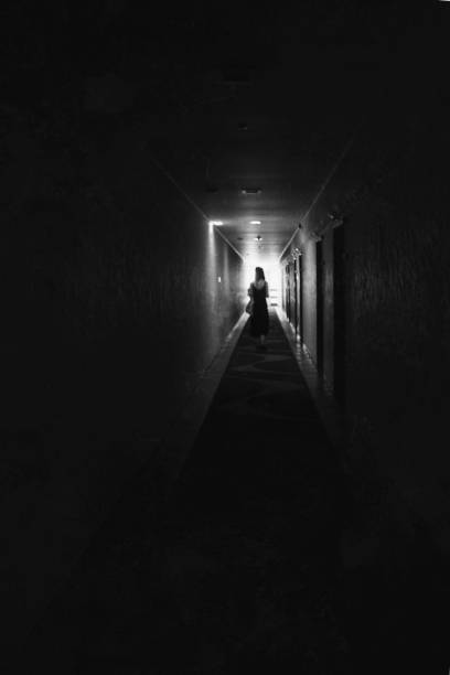 istock Mysterious woman in hotel corridor 1337292142