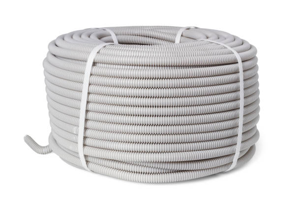 Corrugated hose for electrical wiring Coil of non-combustible corrugated hose for laying electrical wiring isolated on white background pvc conduit stock pictures, royalty-free photos & images