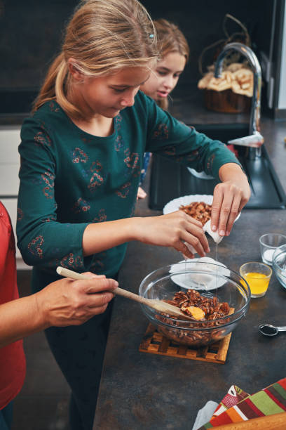 istock Mother and Teens Preparing Pecan Pie for the Holidays 1337300829