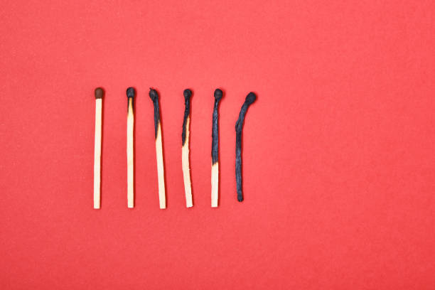 istock Different stages of match burning red background 1337304095