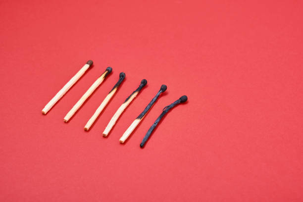 istock Different stages of match burning red background 1337304098