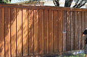istock Pressure washing old fence 1337305847