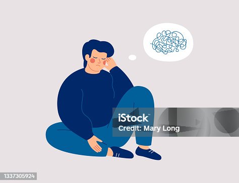 istock Sad man sits on the floor with tangled thoughts. The unhappy boy has confused thinking. The depressed male adolescent has memory problems 1337305924
