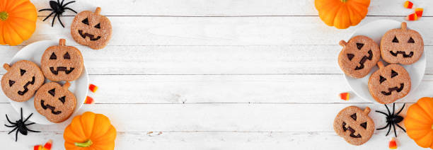istock Halloween Jack o Lantern cookie double border on a white wood background 1337306466