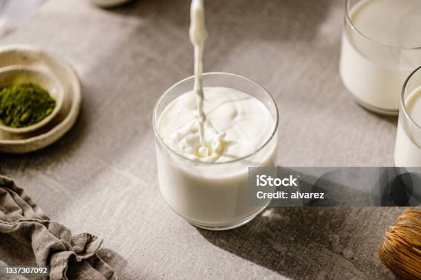 Pouring Fresh Milk In Glass Stock Photo - Download Image Now - Milk, Drinking Glass, Pouring