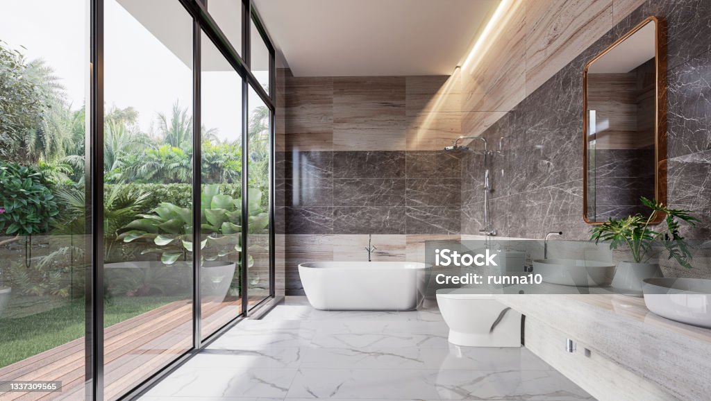 Modern luxury bathroom with tropical style garden view 3d render Modern luxury bathroom with tropical style garden view 3d render,There are marble floor and wall and copper frame mirror,Rooms have large windows, overlook nature view. Bathroom Stock Photo