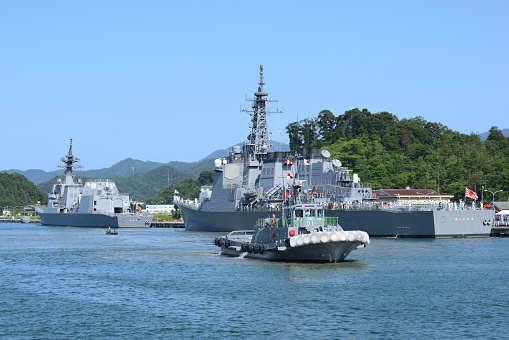 A grey navy warship anchored at sea