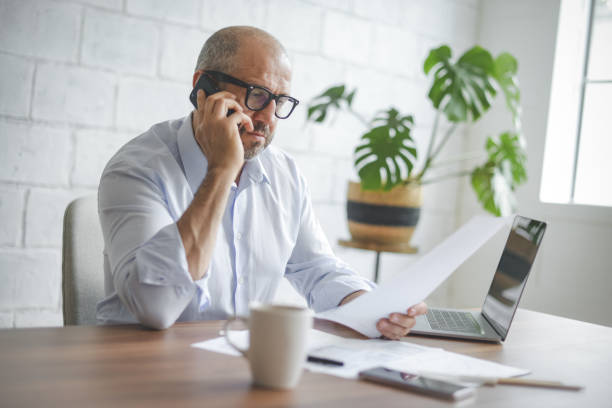 istock mature adult man working from office ( with laptop,paperwork) 1337310411