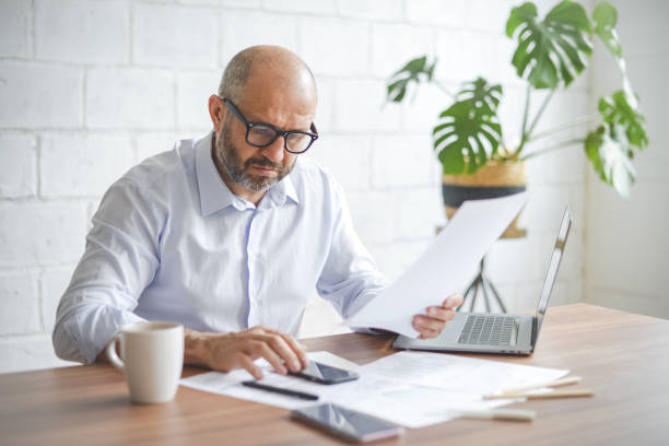 istock mature adult man working from office ( with laptop,paperwork) 1337310868