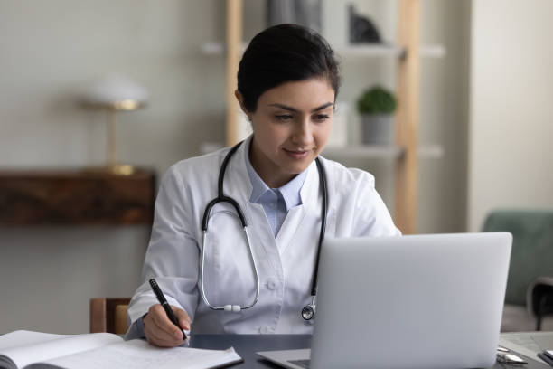 istock Concentrated millennial indian therapist working on computer. 1337312718
